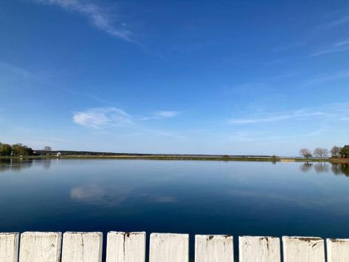 a view of a lake with a wooden fence at Sadama Stay in Haapsalu