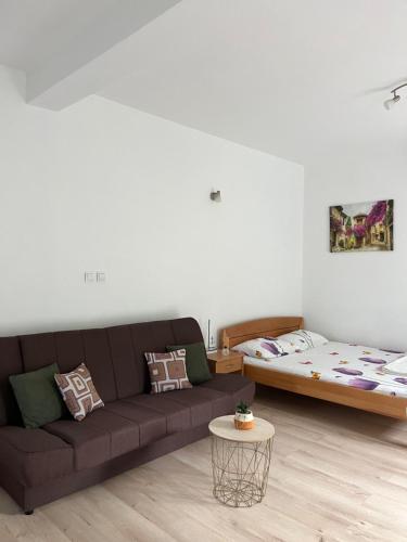 a living room with a couch and a bed at Apartman Iskra in Bijela
