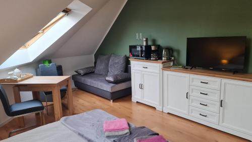 a living room with a couch and a flat screen tv at Strand4-Quartier Ferienwohnungen Ostseebad Karlshagen in Ostseebad Karlshagen