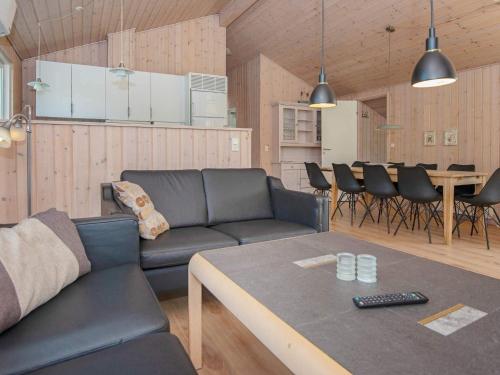 a living room with a couch and a table at 10 person holiday home in B rkop in Egeskov