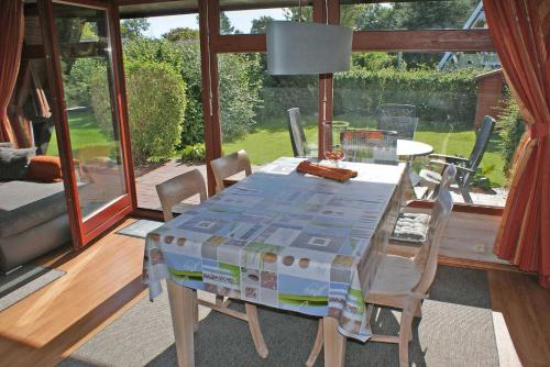 a dining room table with a box on top of it at Urlaub fuer die ganze Familie im Z in Damp