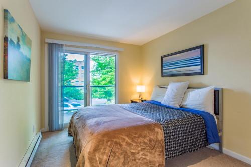 a bedroom with a bed and a large window at the Lanai, Best Area, 2 Bedrooms, WD, Large Balcony, Condo, 825sf in Tacoma