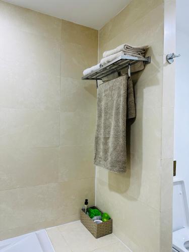 a bathroom with a towel rack and a shower at Lujoso aprtamento cap tingis playa tanger in Tangier