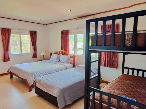 a bedroom with two beds and a bunk bed at The Park Pool Villa Pattaya in Pattaya Central
