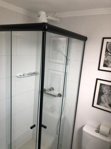 a glass shower in a bathroom with a toilet at Rua Dr Diogo de Faria, 671 apto 81 in Sao Paulo