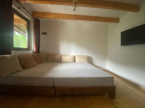 um sofá branco num quarto com uma janela em Cabana Gavroche em Moara Ungurului