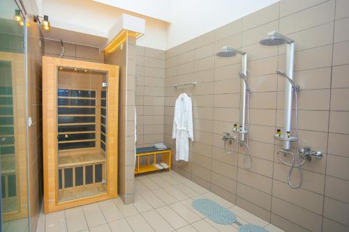 a bathroom with a shower and a glass door at Casa De Potie in Chania Town