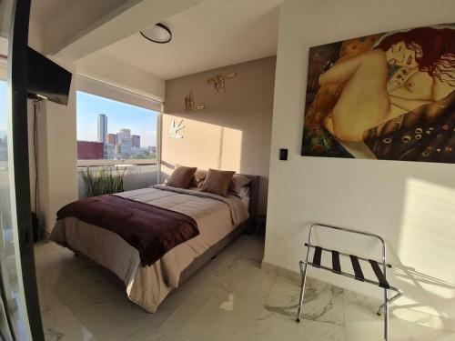 um quarto com uma cama e uma grande pintura na parede em Bright APT w/view near Reforma em Cidade do México