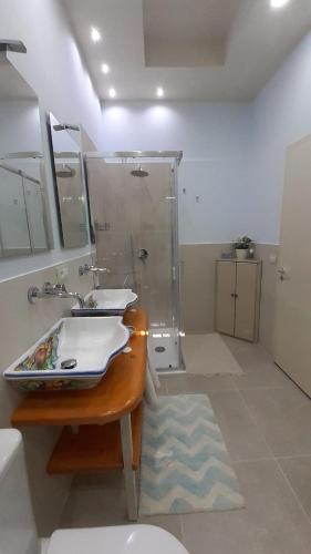a bathroom with a sink and a shower at B&B Affittacamere La Dolce Mela in Francavilla di Sicilia