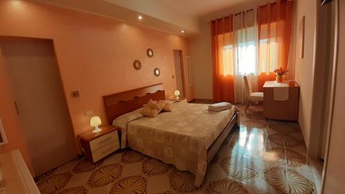 a bedroom with a large bed and a window at B&B Affittacamere La Dolce Mela in Francavilla di Sicilia