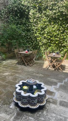 a table and chairs on a patio with a table and a cake at L'ISLE in Beaucaire