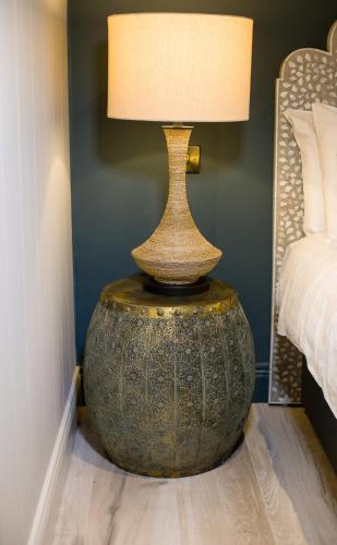 a lamp on a table next to a bed at The Lodges at Castle Lodge in Killarney