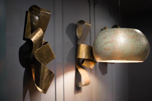 a lamp and a vase hanging on a wall at The Lodges at Castle Lodge in Killarney