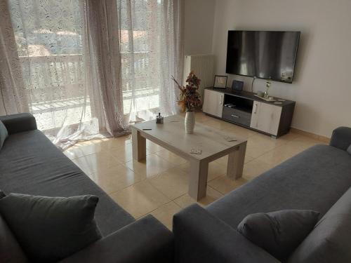 a living room with a couch and a coffee table at Ina House in Samos