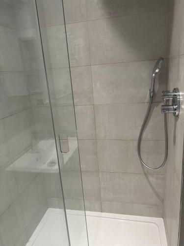 a bathroom with a shower with a glass door at 1 bed Apartment in Whitechapel in London