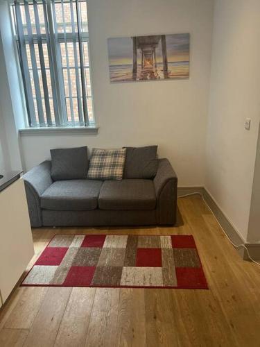 a living room with a couch and a rug at 1 bed Apartment in Whitechapel in London