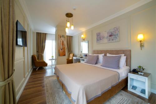 a bedroom with a large white bed in a room at Villa Vanilla Hotel & SPA Istanbul Asia in Istanbul