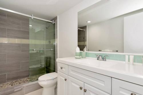 y baño con aseo, lavabo y ducha. en SPECIAL Beautiful Modern Beach Condo, en Miami Beach