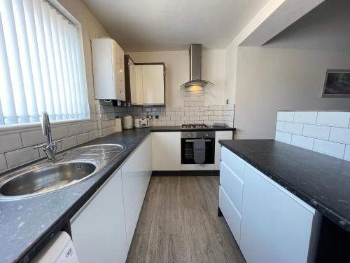 a kitchen with a sink and a counter top at Jacksons Modern Retreat Close to Tynemouth in Tynemouth