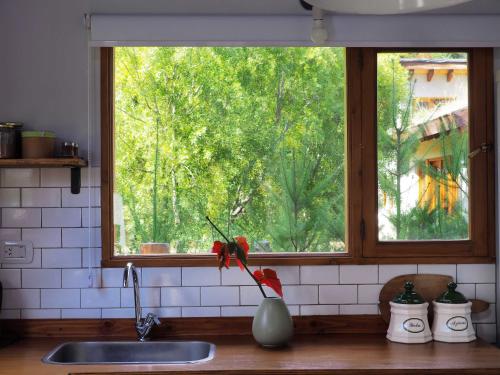 a kitchen sink with a window in a kitchen at Casa Lali in Lago Puelo