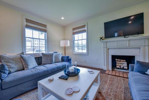 a living room with blue couches and a fireplace at Bama Hideout in Tuscaloosa