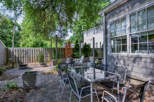 a patio with a table and chairs next to a house at Bama Hideout in Tuscaloosa
