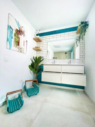 a room with two blue chairs and a mirror at Sunrise IN LOFT in Playa Honda