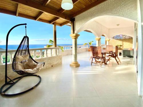 a porch with a hammock on a house at Inviting 2-Bed Apartment in Cofresi in Las Flores