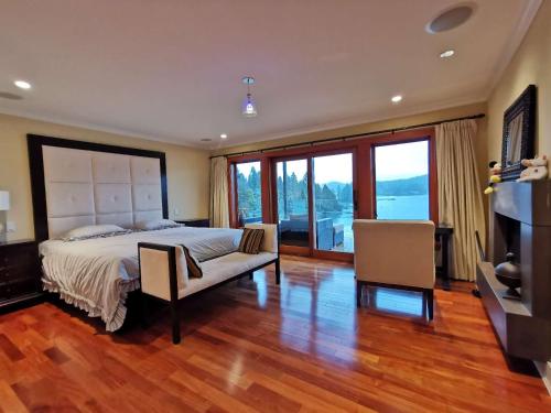 a large bedroom with a bed and a television at Deep Cove Stunning Waterfront Whole House in North Vancouver