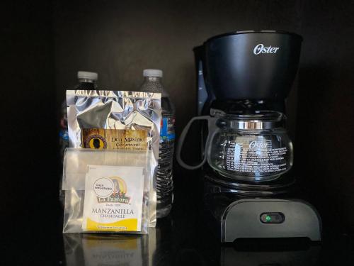 a counter with a coffee maker and a bottle of water at Casa Anguiano Valle de Guadalupe in Valle de Guadalupe