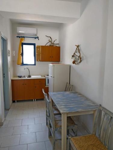 a kitchen with a table and a refrigerator at Perasma Apartments in Kypri