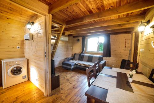 a room with a couch and a table in a cabin at Górska Chatka in Bukowiec