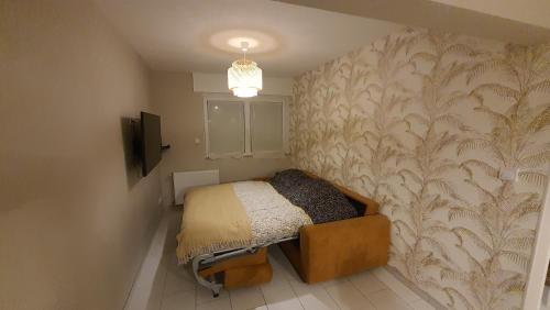 Dormitorio pequeño con cama y pared en Maison La Côte, en Boulogne-sur-Mer
