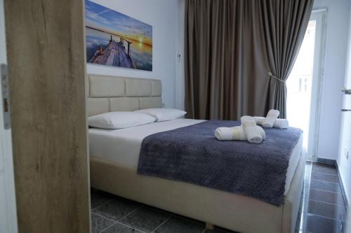 a bedroom with a bed with two towels on it at Fishta apartments Q5 32 in Velipojë