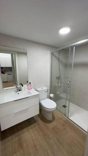 a bathroom with a toilet and a sink and a shower at RockSide Residences Suites La Línea VII in La Línea de la Concepción