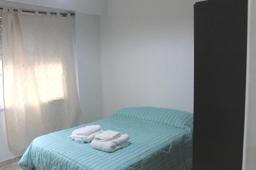 Una habitación con una cama con toallas. en Apart Obelisco II en Buenos Aires