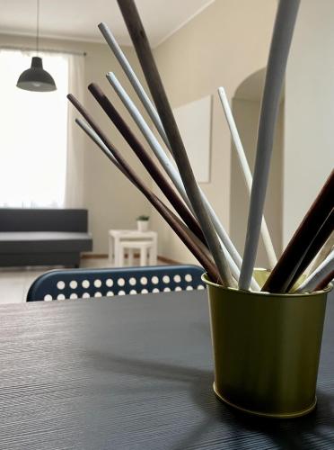 a container filled with utensils sitting on a table at Grey Apartment in Caiazzo