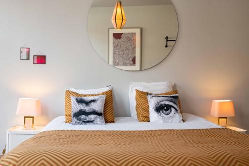 a bedroom with a bed with a mirror on the wall at Belle de Nuit in Ostend