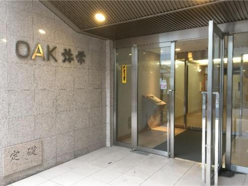 an entrance to an office building with a revolving door at OAK Yasaka / Vacation STAY 477 in Osaka