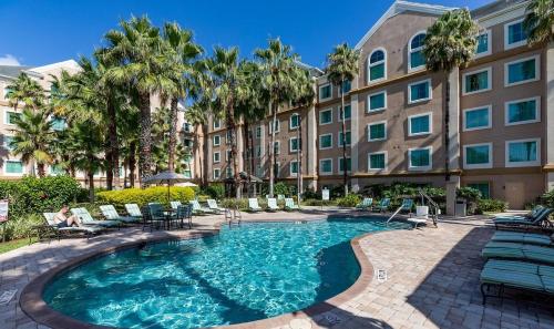 a swimming pool in front of a building at Charming suite in a condotel close to Disney in Orlando