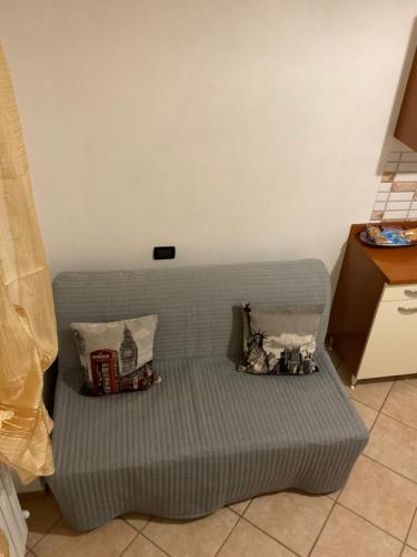 a couch with pillows on it in a room at Da Lisa in Ortona