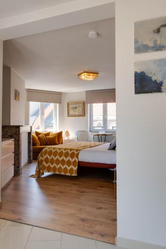 a bedroom with a bed and a couch at Belle de Nuit in Ostend
