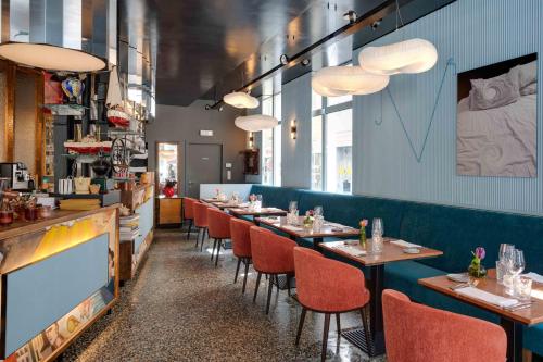 a restaurant with a row of tables and chairs at Belle de Nuit in Ostend