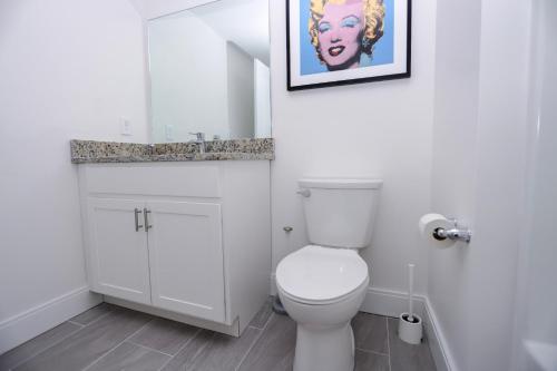 a bathroom with a toilet and a picture on the wall at 1BR Luxury Apartment Peabody Unit 709 in Peabody