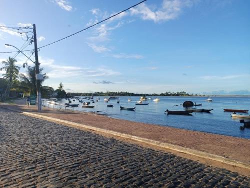 a group of boats in the water on a street at Residencial Lucernaré - Pontal in Itacaré