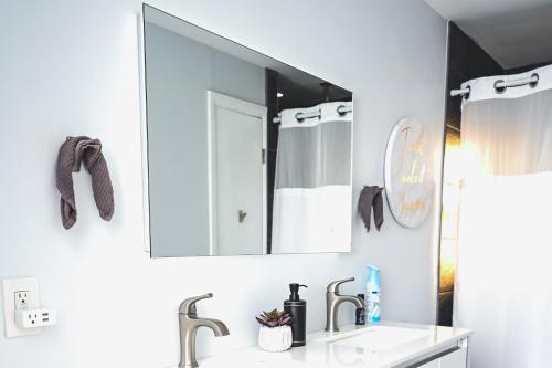 a bathroom with a sink and a mirror at Cozy Oasis: Luxury & Modern Apartment By Revere Beach in Revere