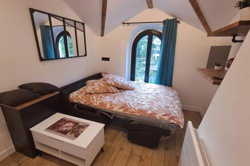 Un dormitorio pequeño con una cama y una ventana. en Petit-cocon proche centre-ville, en Caluire-et-Cuire