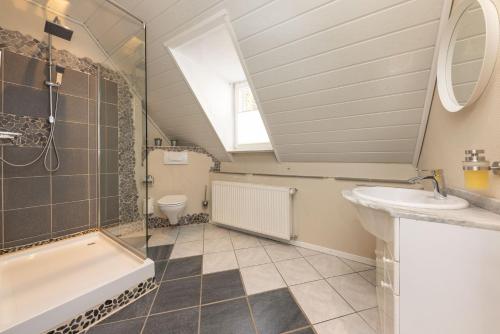 a bathroom with a sink and a shower and a toilet at FerienNest Haus Braunfels in Bad Ems