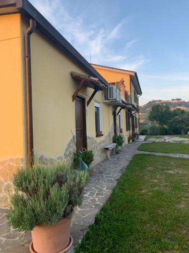 a row of houses with potted plants in front of them at B & B Almalù in Ripatransone