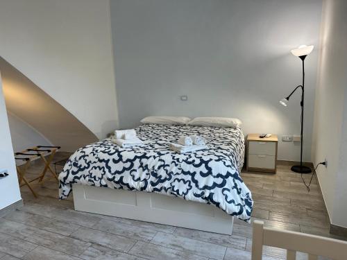 a bedroom with a bed with a black and white comforter at Holiday Home Vietri sul mare in Vietri sul Mare
